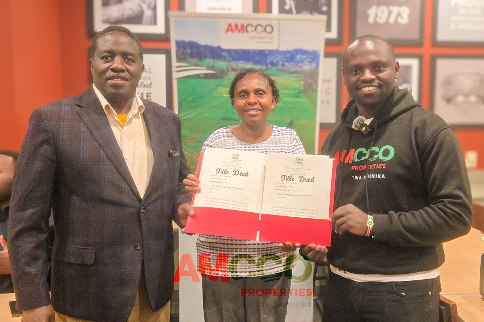 Happy AMCCO Diaspora Land Owner A couple receives their Title Deed delivered from Kenya by AMCCO Properties